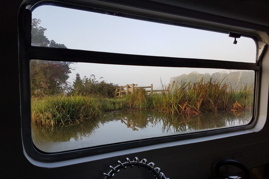 the canal through the window on a boutique narrowboat