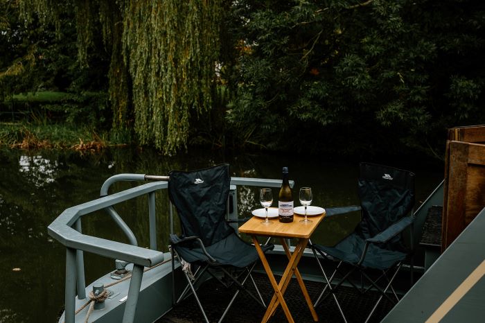 Sipping wine outside on a canal boat holiday in the autumn