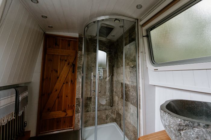 Contrast marble and reclaimed wood on a luxury canal boat holiday